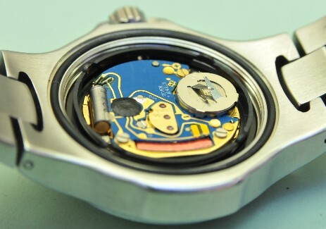 Tag Heuer watchcase with the back off showing the movement with that newly installed battery.
